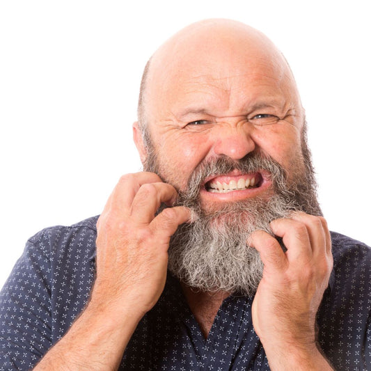 Man scratching itcy beard